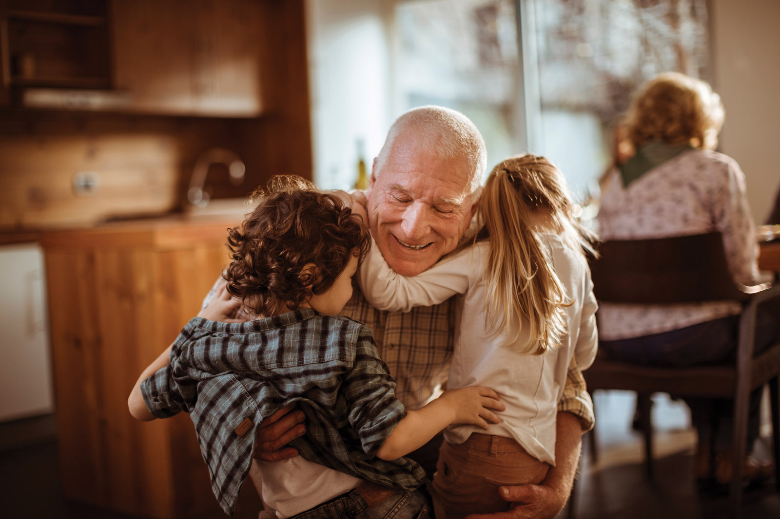 Granddad hugging kids